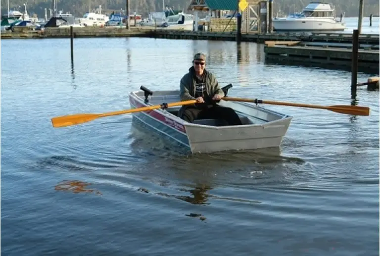 Guy rowing a Jon boat