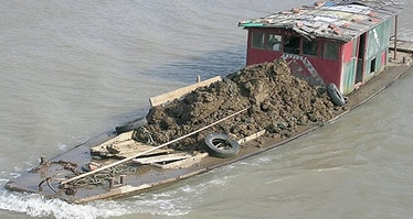 overloaded flat bottom freight boat