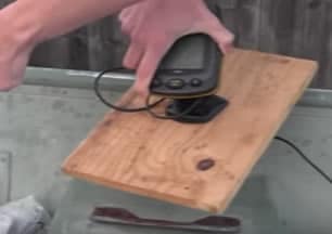 Fish finder console attached to wooden board