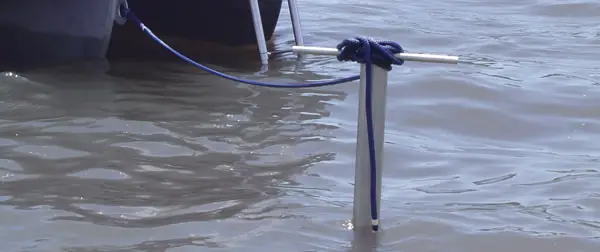 boat tethered to shallow water pole