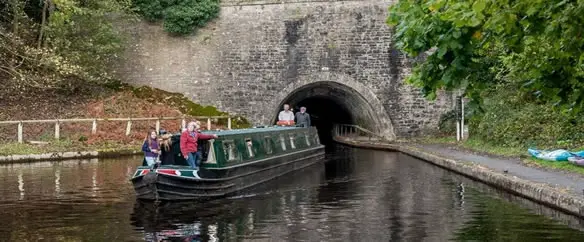 narrowboat coming out of tunnel