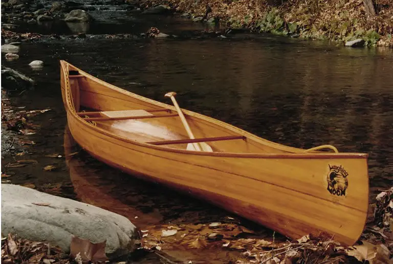 indian children sail in dugout canoe on coco river