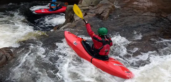 whitewater sit-in kayak in rapids