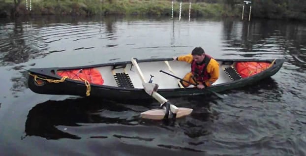 Canoeist demonstrating the extra stability offered by a single outrigger