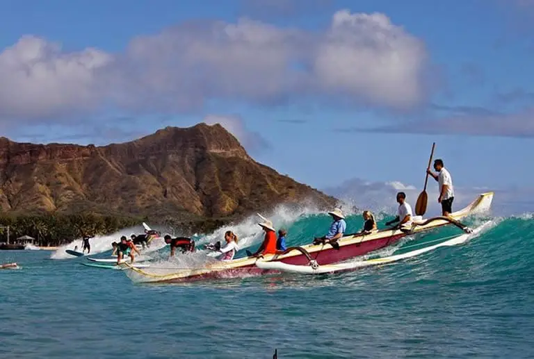 Outrigger canoe riding a wave