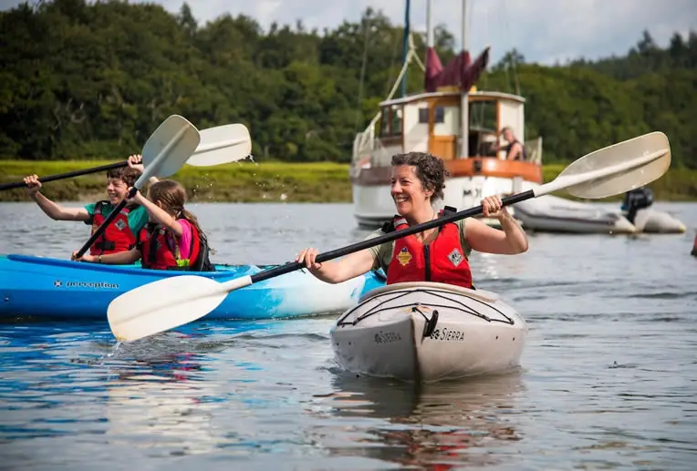 Healthy happy people kayaking