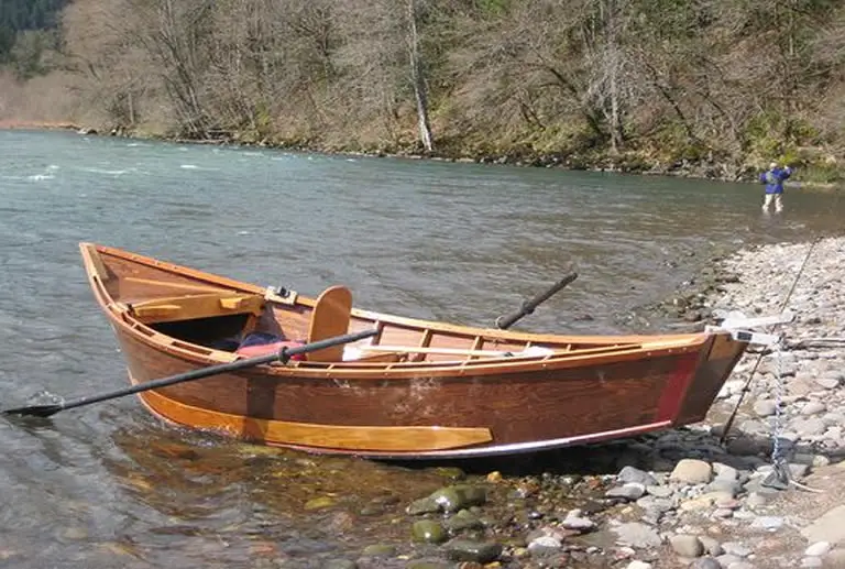 A drift boat anchored on river