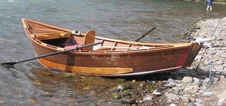 A wooden drift boat at bank
