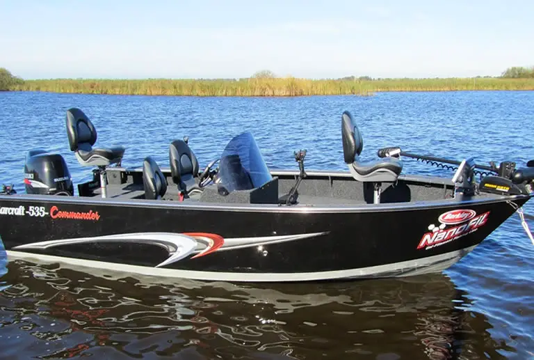 Bass boat in shallow lake water