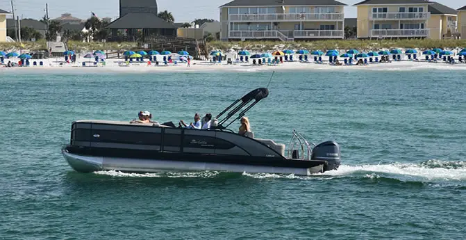 pontoon boat in ocean close to shoreline