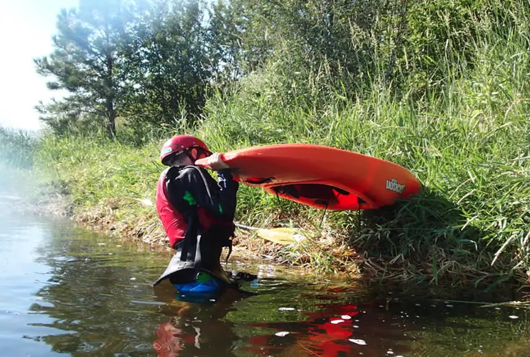 Draining water from river kayak