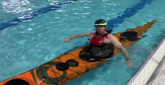 Foam filled kayak floating just beneath the waterline with paddler still inside