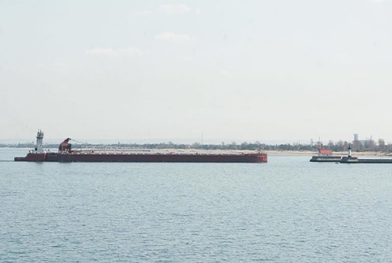 Tug barge approaching bay from ocean