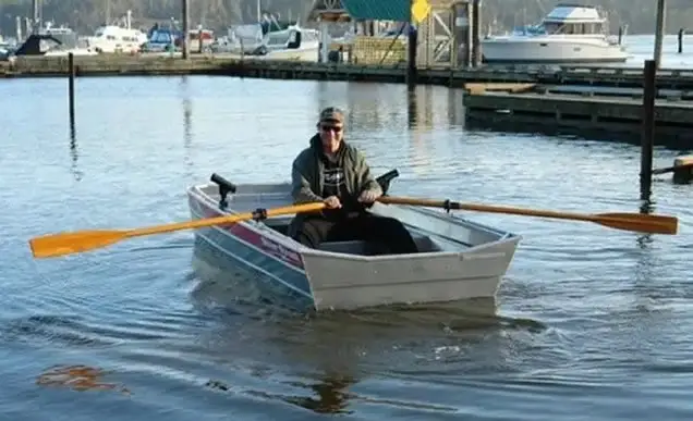 Guy rowing Jon boat
