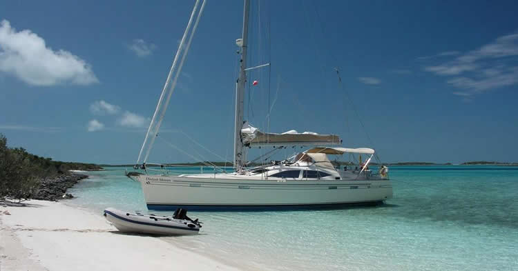 Shoal sailboat in shallows near beach